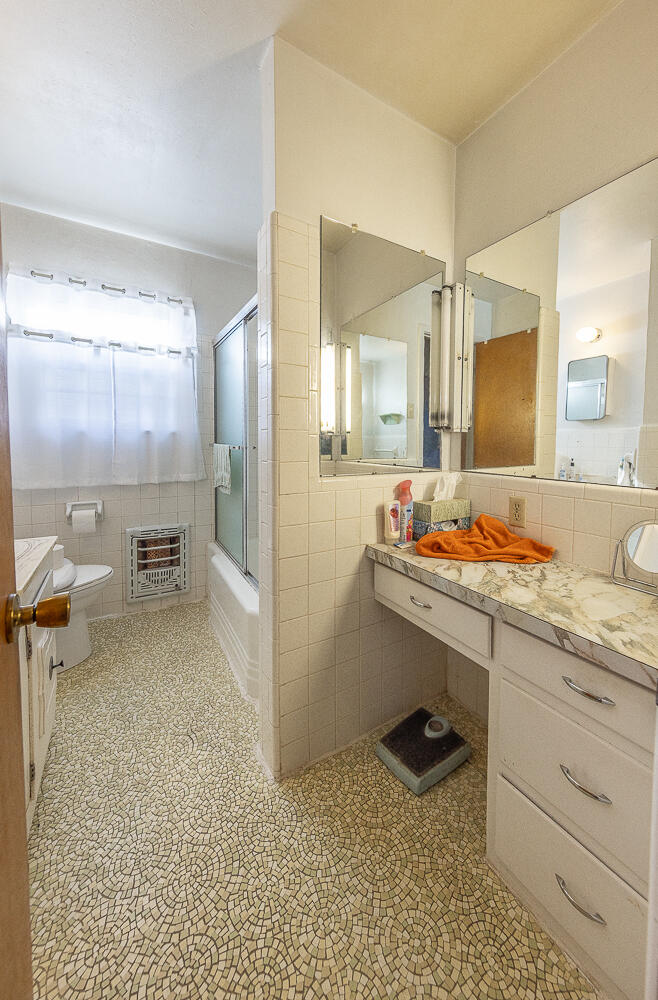 1918 42nd Street Lubbock, TX 79412 - Photo 15 of 29 a bathroom with a sink double vanity and a mirror
