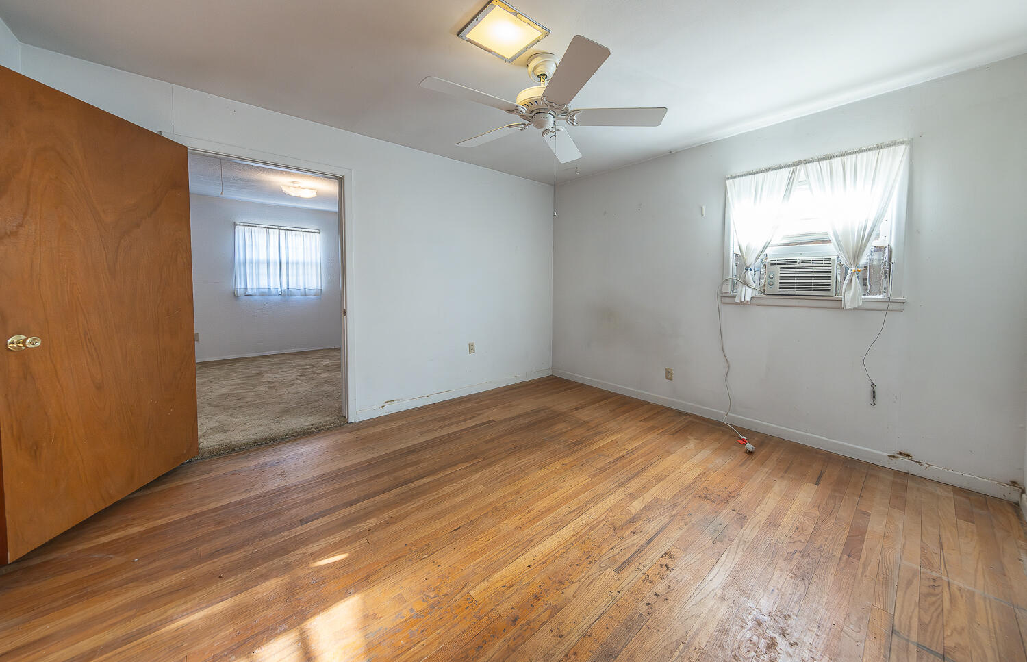 1918 42nd Street Lubbock, TX 79412 - Photo 16 of 29 wooden floor in an empty room with a window