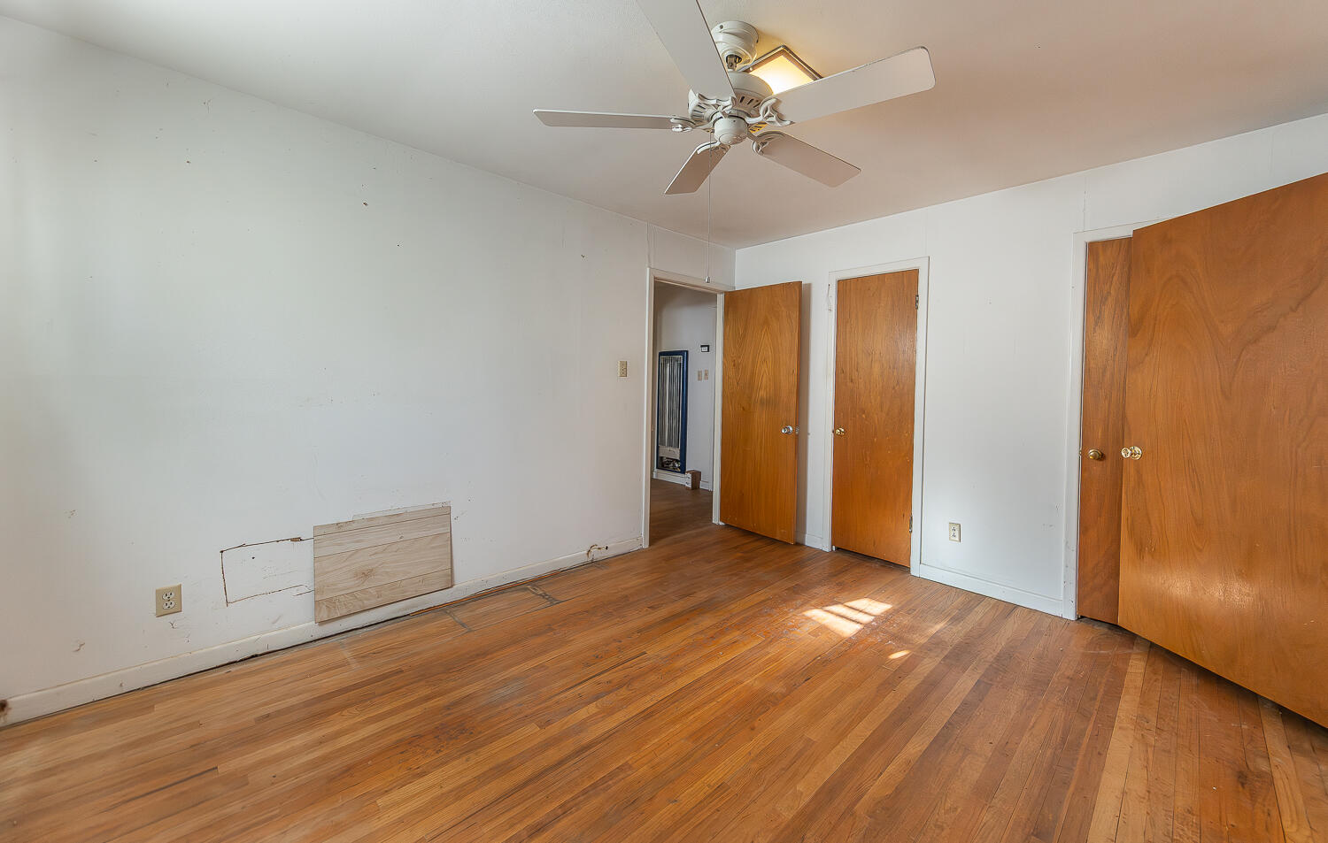 1918 42nd Street Lubbock, TX 79412 - Photo 17 of 29 an empty room with wooden floor and ceiling fan