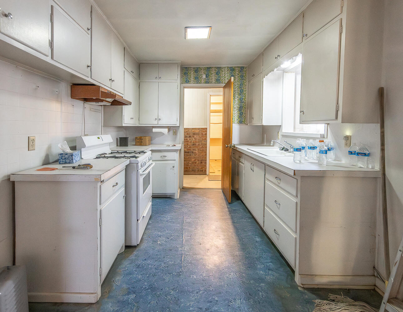1918 42nd Street Lubbock, TX 79412 - Photo 3 of 29 a kitchen with a sink stove cabinets and wooden floor