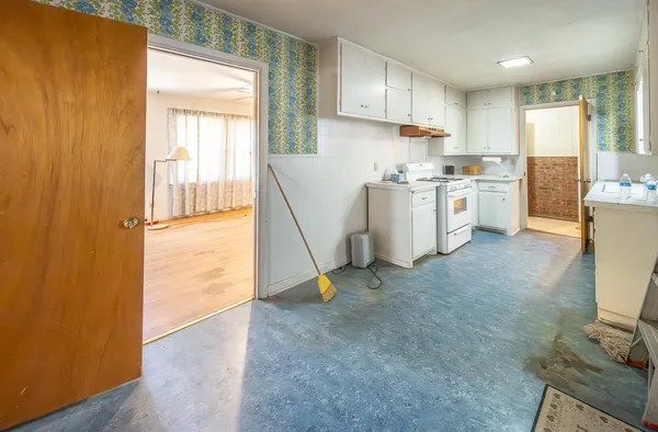a kitchen that has a sink and a stove