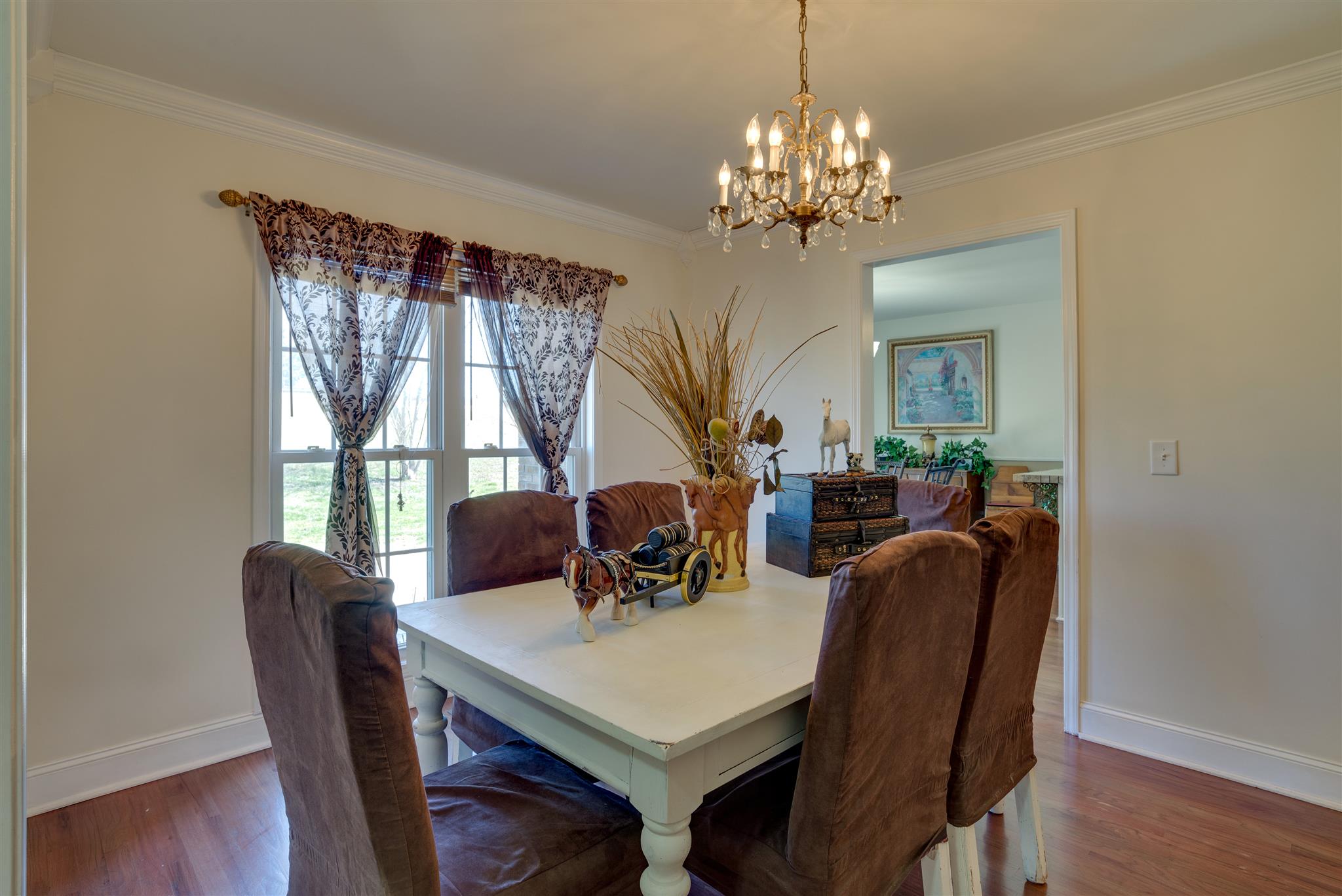 2225 Clara Mathis Road Spring Hill, TN 37174 - Photo 4 of 19 a view of a dining room with furniture a chandelier and wooden floor