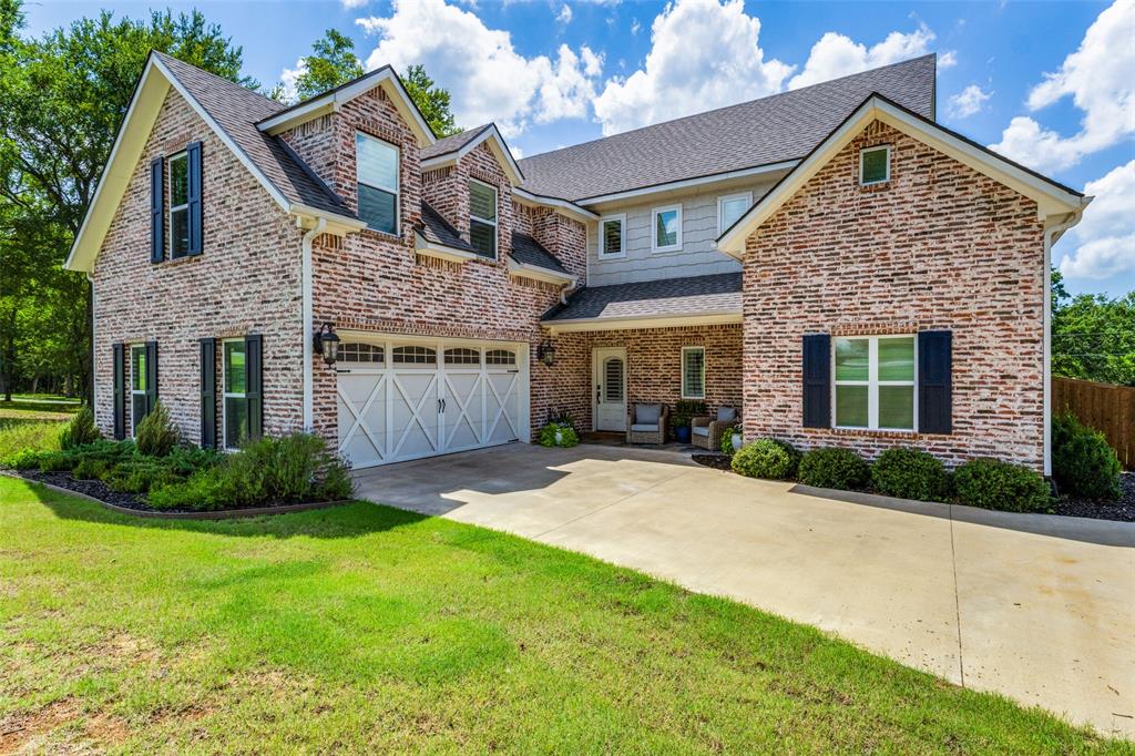 137 White Dove Trail Denison, TX 75020 - Photo 1 of 38 a front view of a house with a yard and garage