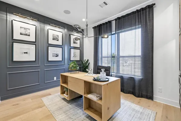 a room with a large window and furniture