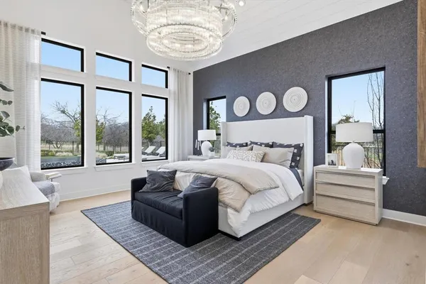 a bedroom with a large bed and a large window
