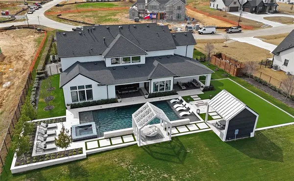 an aerial view of a house with swimming pool garden and patio