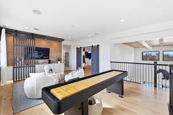 a room with table chairs and wooden floor