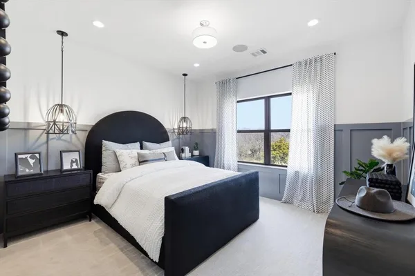 a bedroom with a bed table and window