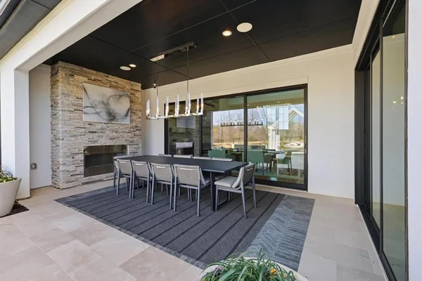 a dining room with furniture a rug and wooden floor