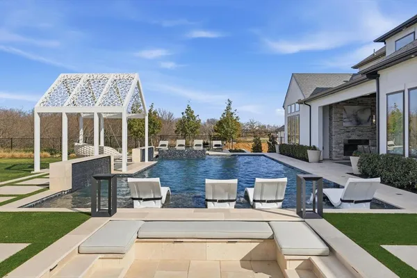a view of a house with backyard porch and sitting area