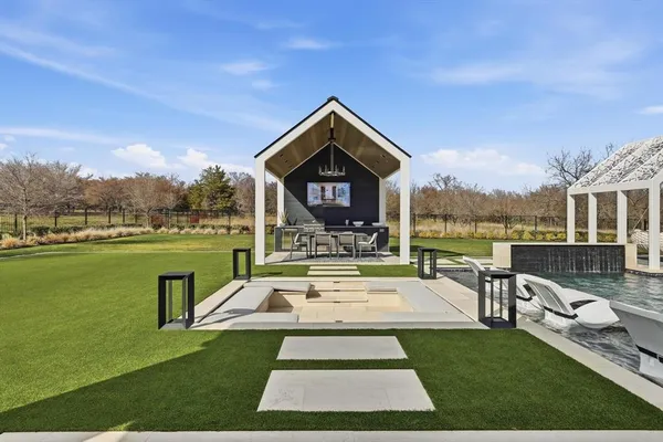 a view of a house with garden and a patio