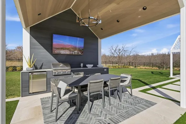 a view of a patio with a table and chairs