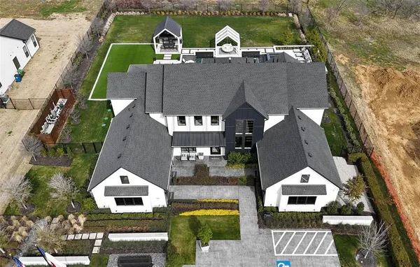 a aerial view of a house with a yard and balcony