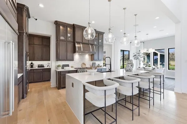 a large kitchen with a table and chairs