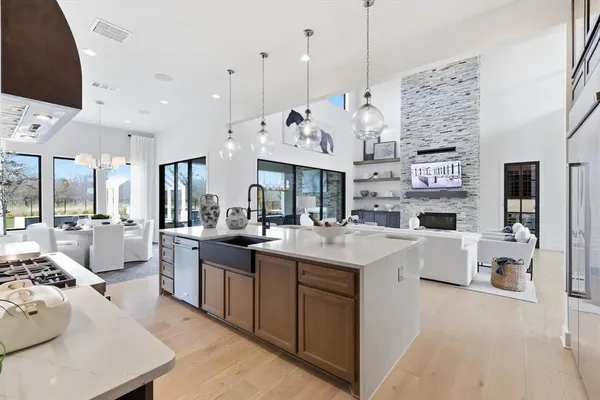 a large kitchen with stainless steel appliances kitchen island granite countertop a sink and cabinets