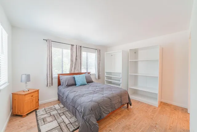 a bedroom with a large bed and a window