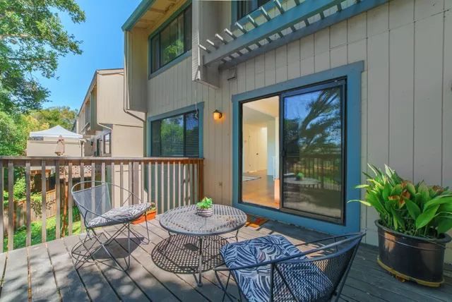 a view of a chair and tables in the backyard