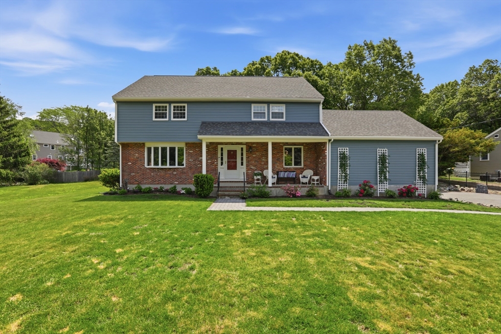 94 Johnson Road Winchester, MA 01890 - Photo 1 of 40 a front view of a house with a garden