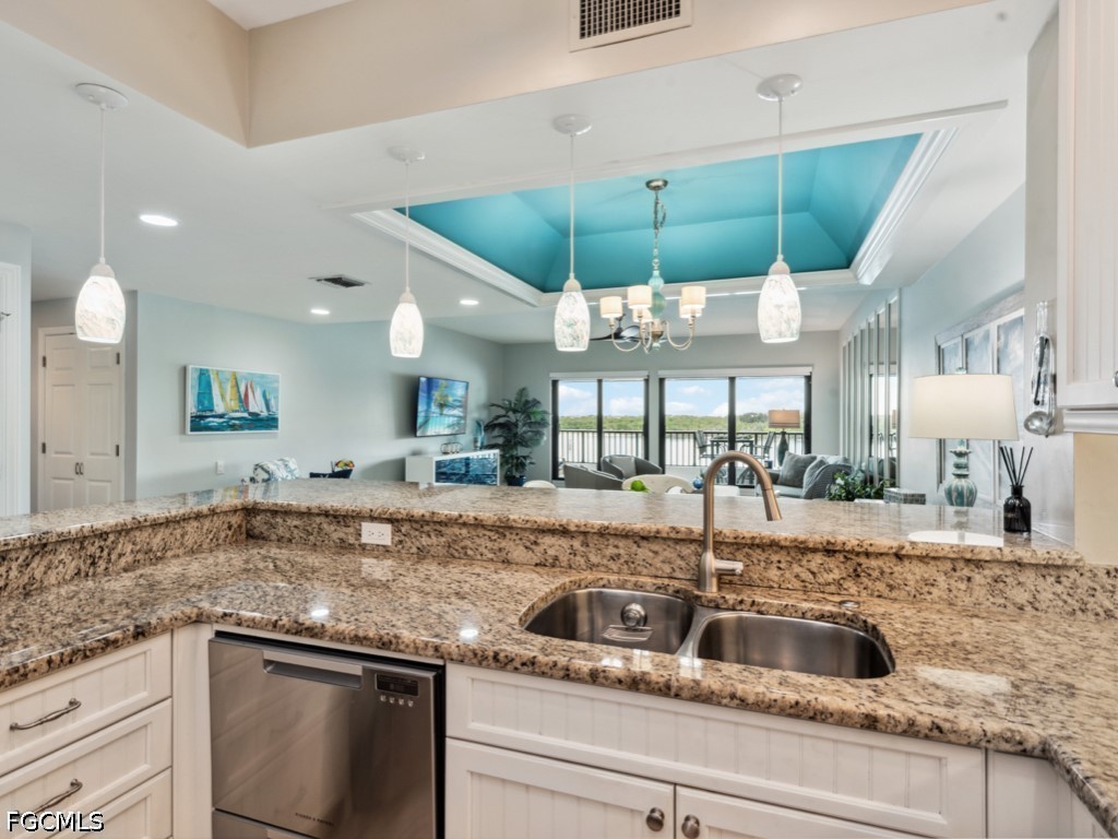 232 La Peninsula Boulevard, Unit 232 Naples, FL 34113 - Photo 5 of 44 a kitchen with a sink and a counter top space