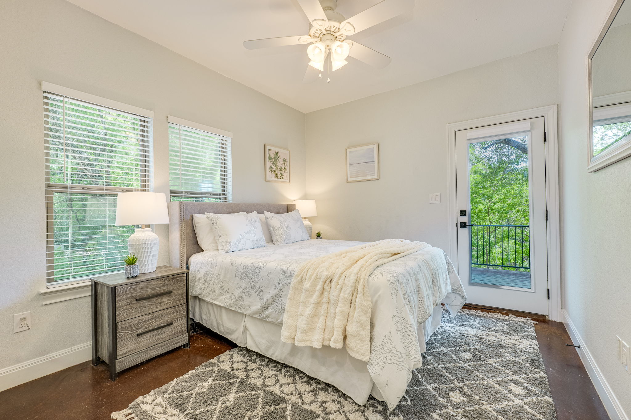 433 Venture Boulevard South Point Venture, TX 78645 - Photo 20 of 36 Tucked on the lower level, this bedroom has its own quiet escape with tree views and direct access to the covered deck.