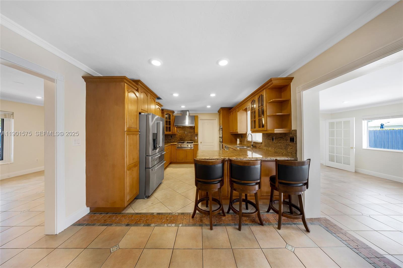 10501 Southwest 126th Avenue Miami, FL 33186 - Photo 12 of 42 a dining hall with stainless steel appliances kitchen island granite countertop a table and chairs