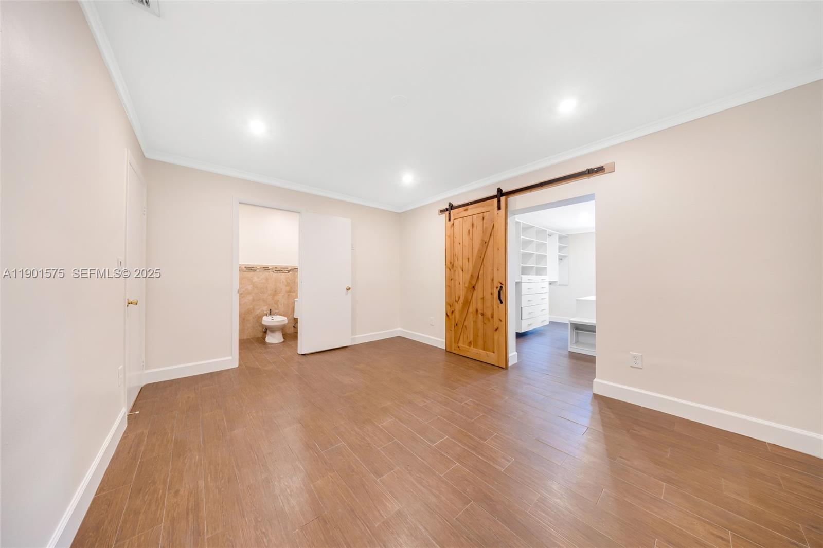 10501 Southwest 126th Avenue Miami, FL 33186 - Photo 21 of 42 a view of an empty room with wooden floor and closet