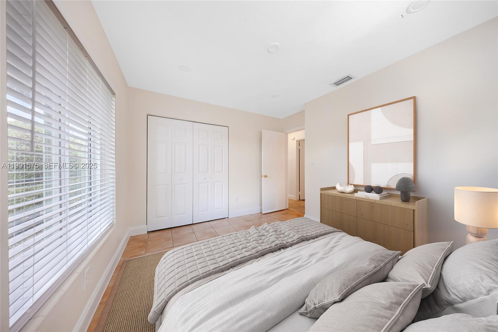 10501 Southwest 126th Avenue Miami, FL 33186 - Photo 27 of 42 a bedroom with a bed and a large window