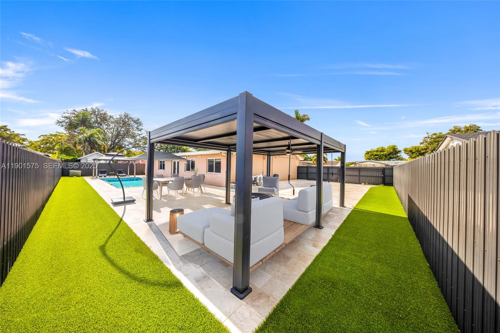 10501 Southwest 126th Avenue Miami, FL 33186 - Photo 30 of 42 a view of a swimming pool with a patio and a backyard