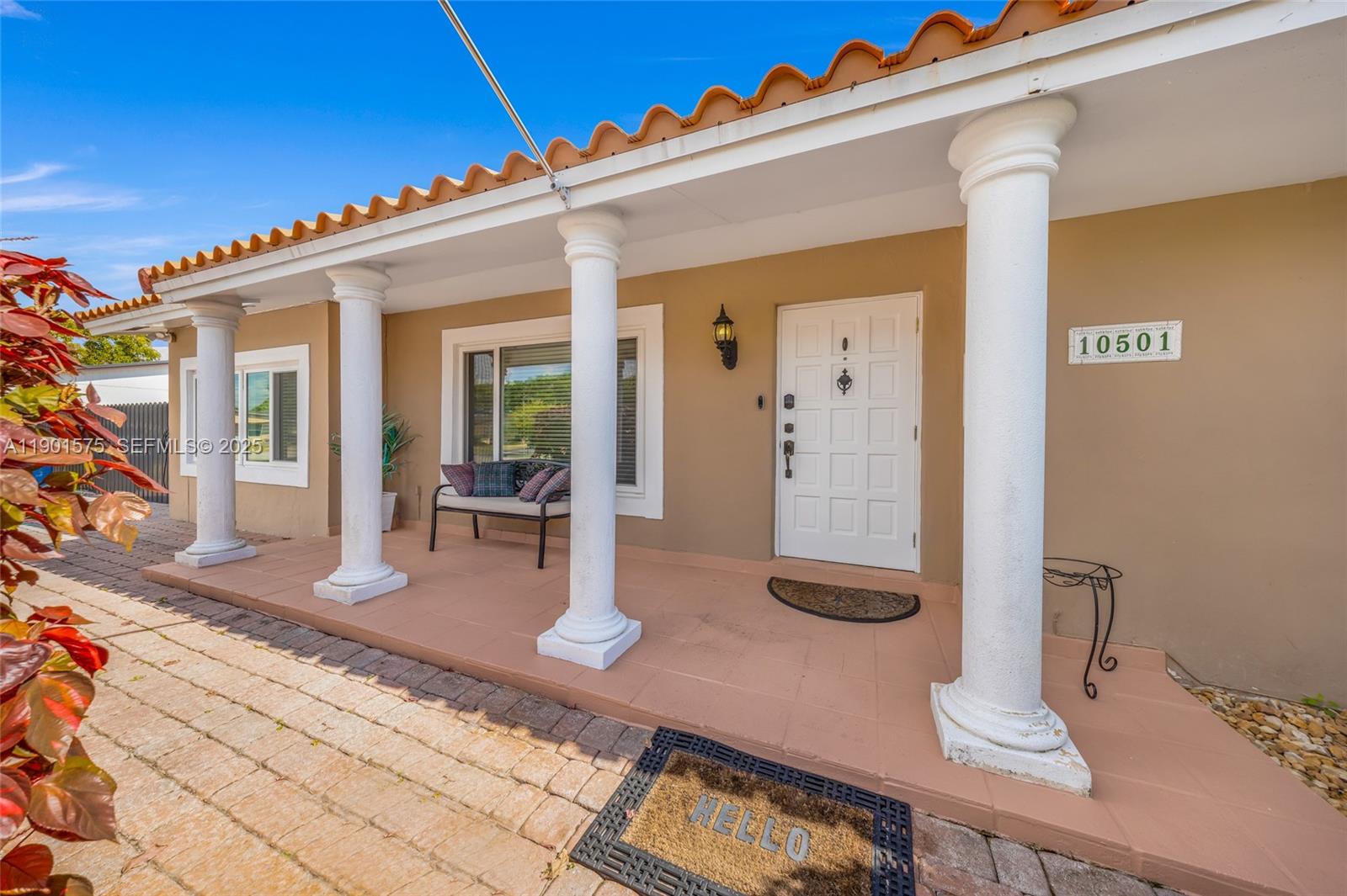 10501 Southwest 126th Avenue Miami, FL 33186 - Photo 3 of 42 a front view of a house with a view of the porch
