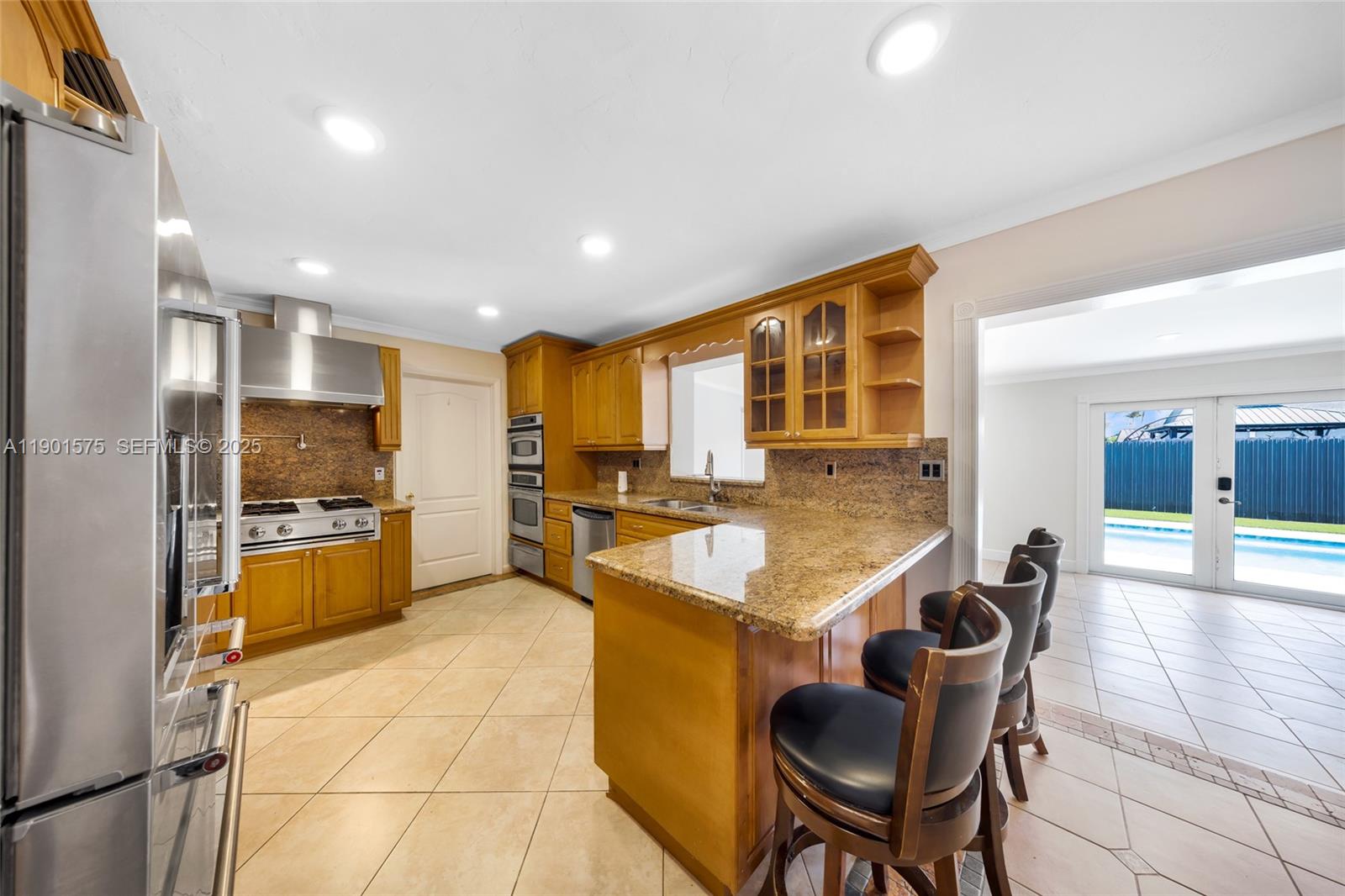 10501 Southwest 126th Avenue Miami, FL 33186 - Photo 41 of 42 a large kitchen with kitchen island granite countertop a large counter top space and stainless steel appliances