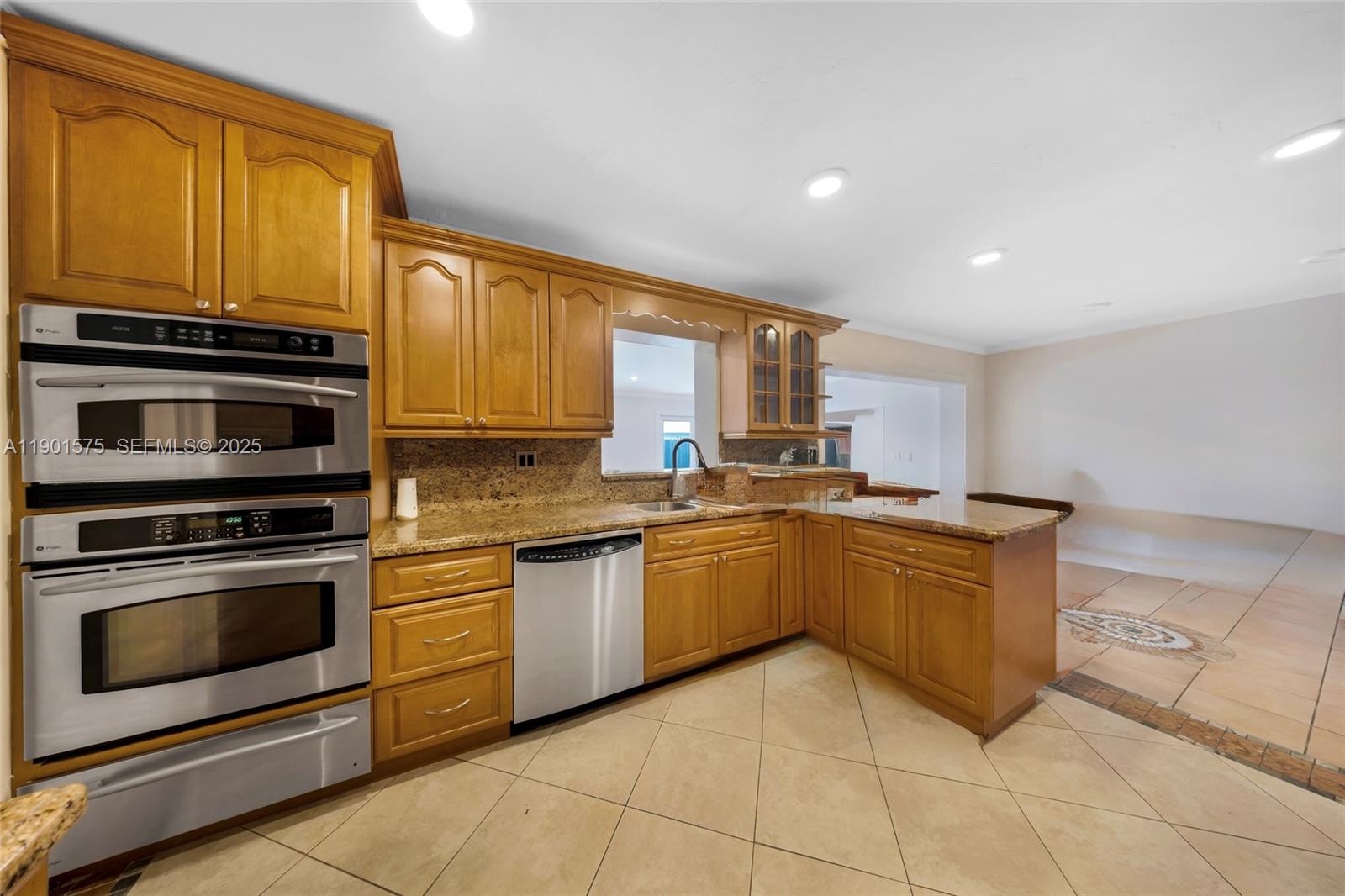10501 Southwest 126th Avenue Miami, FL 33186 - Photo 9 of 42 a kitchen with stainless steel appliances granite countertop a stove a sink and a microwave