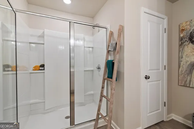 a bathroom with a glass shower door and a glass door