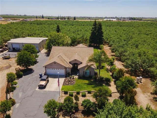 an aerial view of a house with garden space and outdoor seating