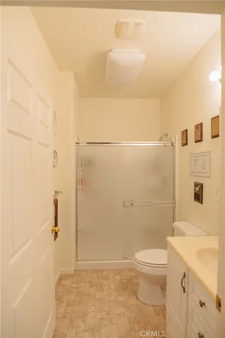 a view of a lake with a bench and trees around