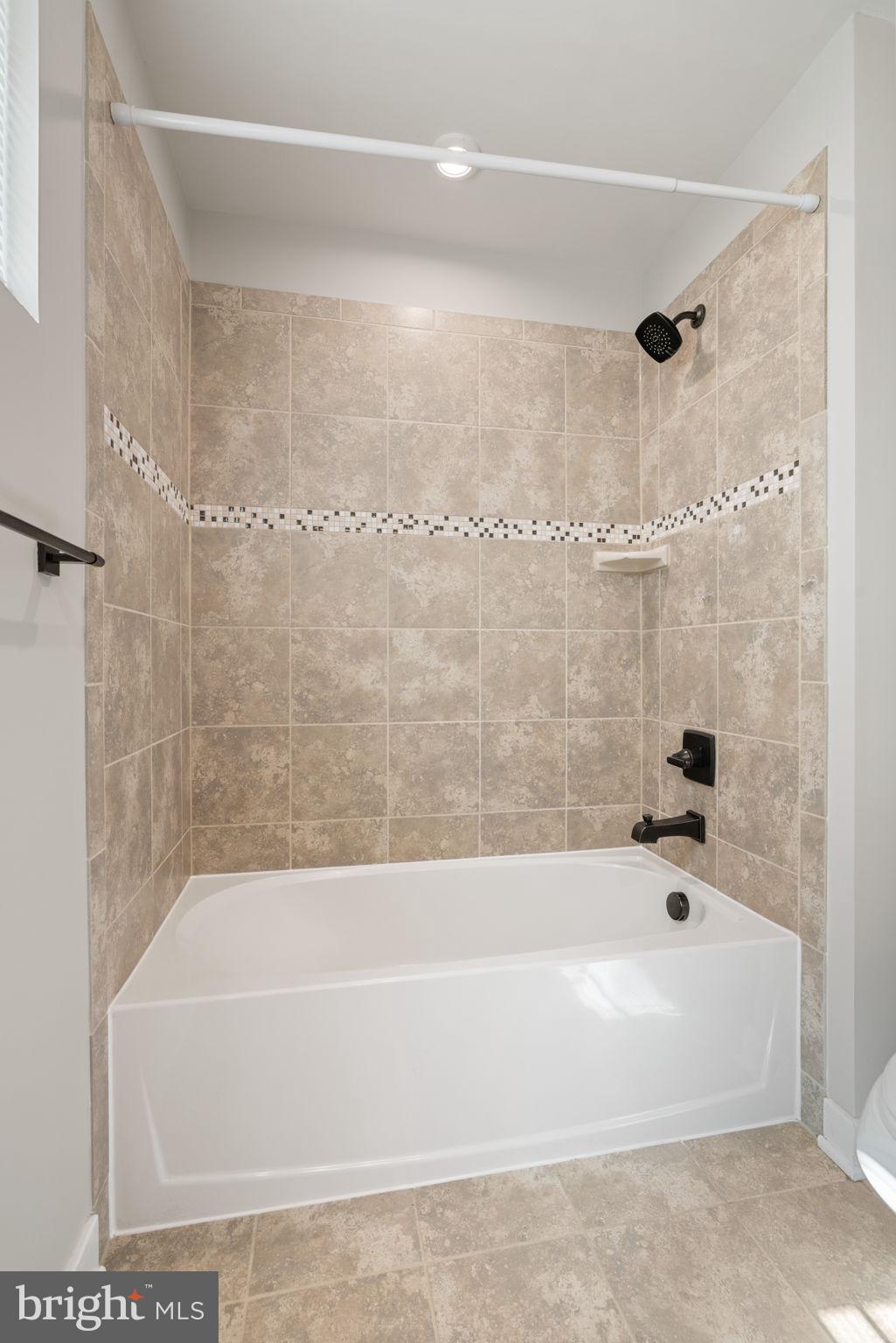 18180 Red Mulberry Road Dumfries, VA 22026 - Photo 34 of 87 a bathroom with a bathtub and shower