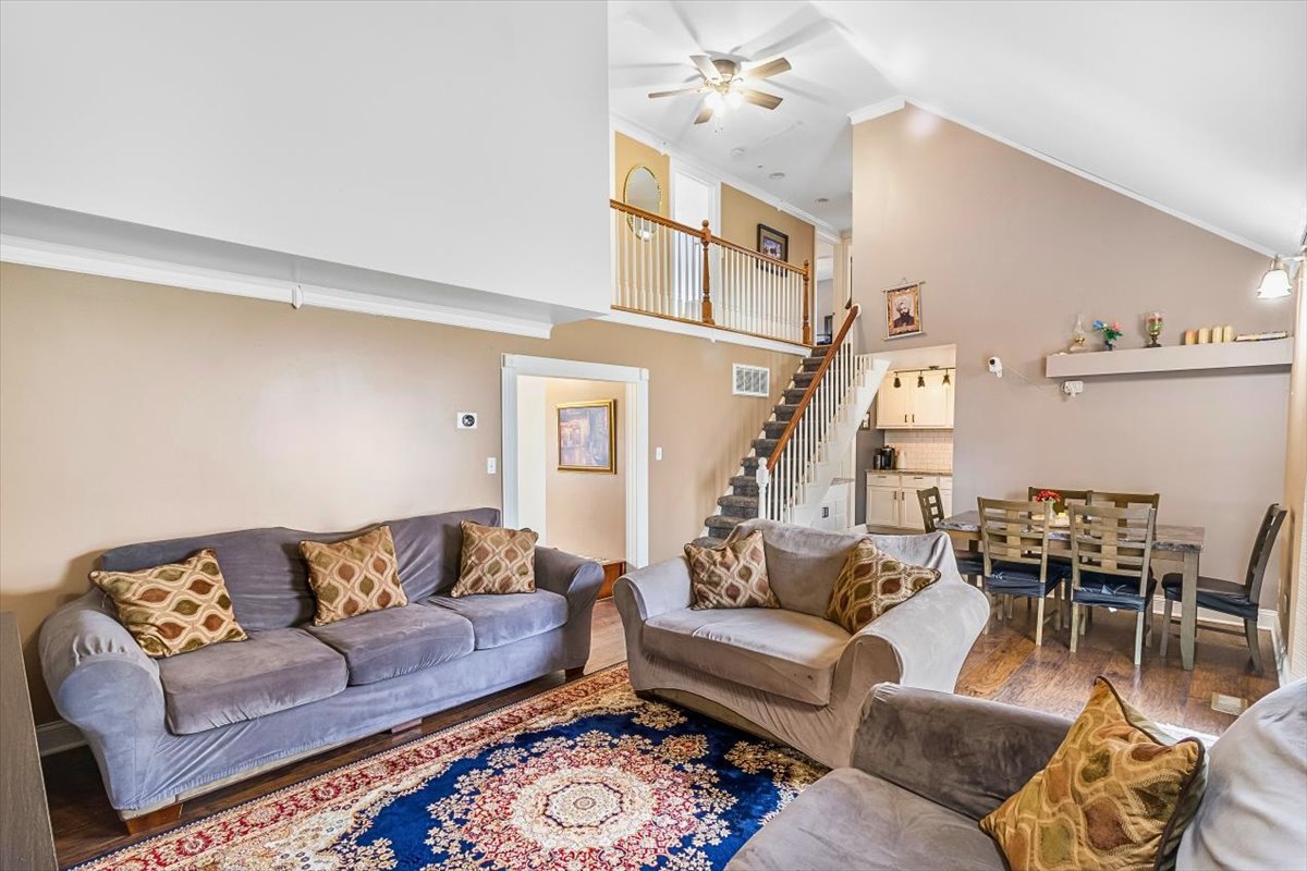 6881 Hickory Street Hanover Park, IL 60133 - Photo 12 of 23 a living room with furniture a rug and a chandelier