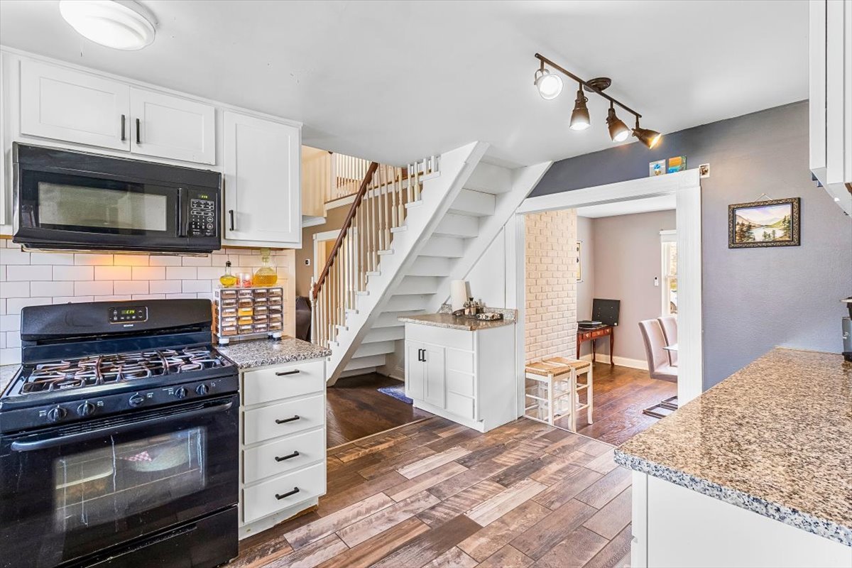 6881 Hickory Street Hanover Park, IL 60133 - Photo 15 of 23 a kitchen with granite countertop a stove and a sink