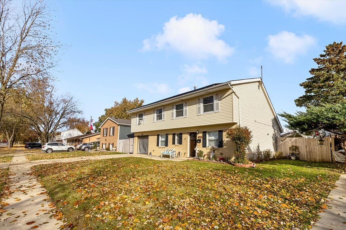 6881 Hickory Street Hanover Park, IL 60133 - Photo 2 of 23 a view of a house with a yard