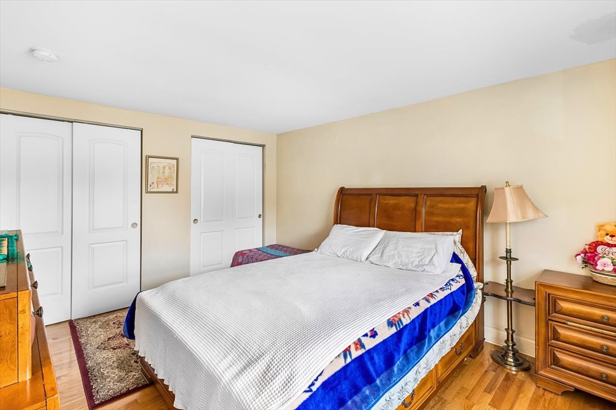 6881 Hickory Street Hanover Park, IL 60133 - Photo 4 of 23 a bedroom with a bed and wooden floor
