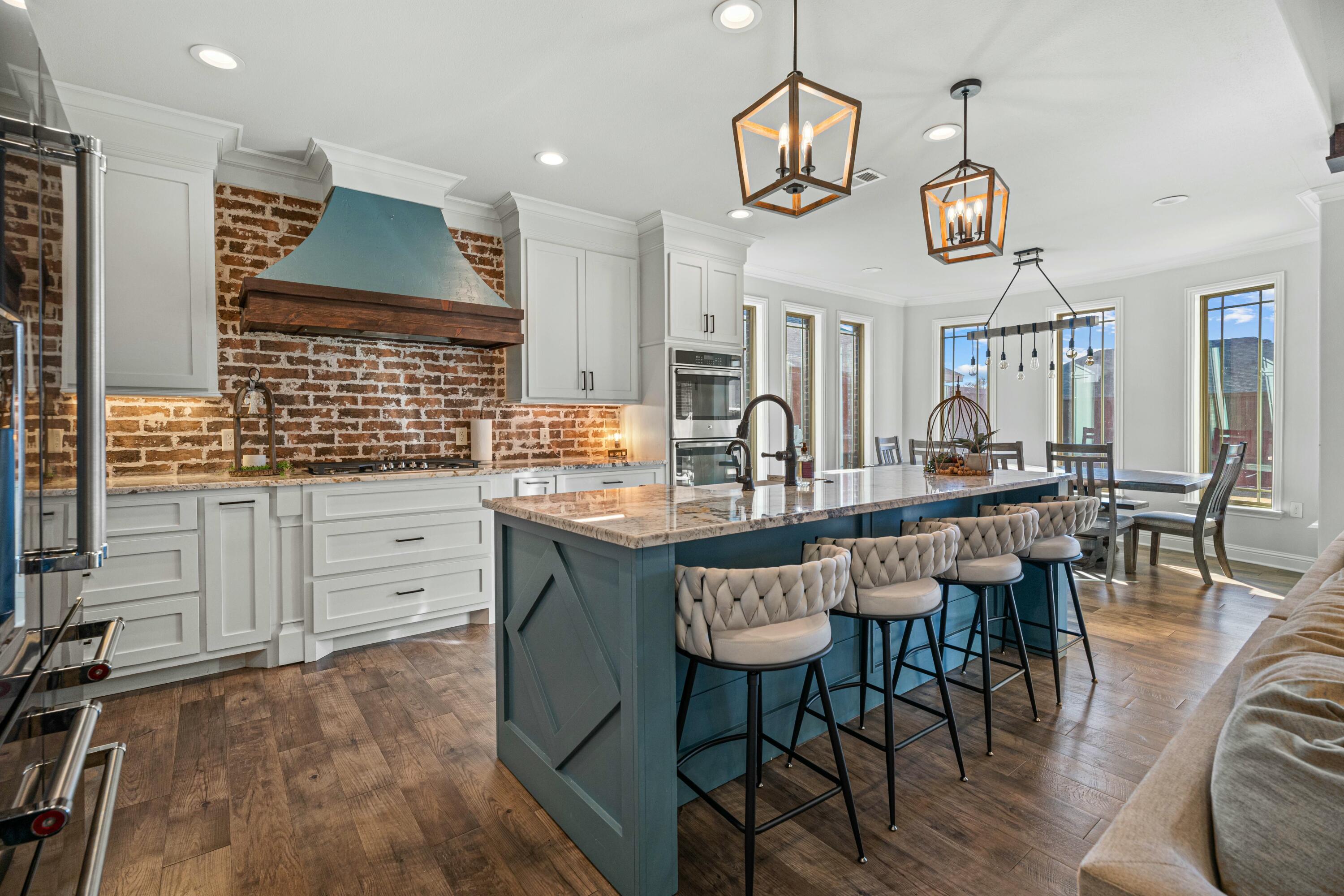 813 Avenue T Shallowater, TX 79363 - Photo 11 of 36 a kitchen with stainless steel appliances granite countertop a kitchen island hardwood floor and a sink