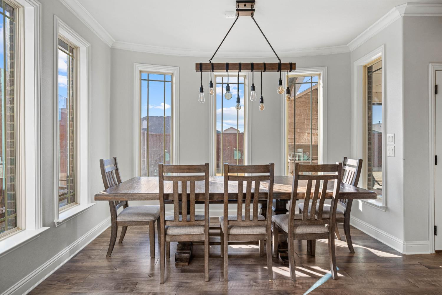 813 Avenue T Shallowater, TX 79363 - Photo 12 of 36 a dining room with furniture a chandelier and wooden floor
