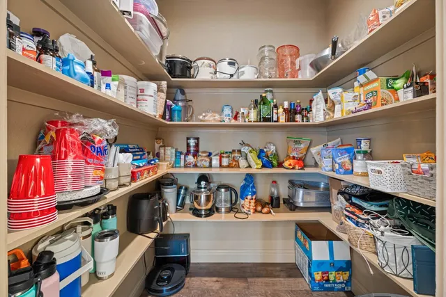 a room with storage and a white refrigerator