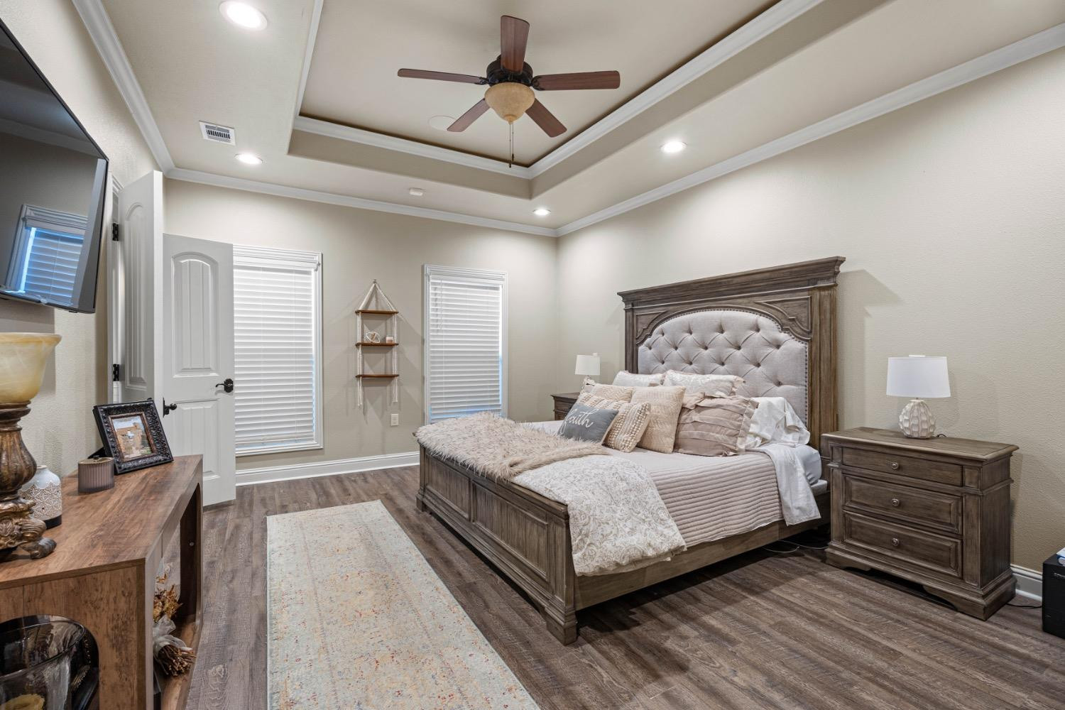 813 Avenue T Shallowater, TX 79363 - Photo 14 of 36 a bedroom with a bed and a chandelier
