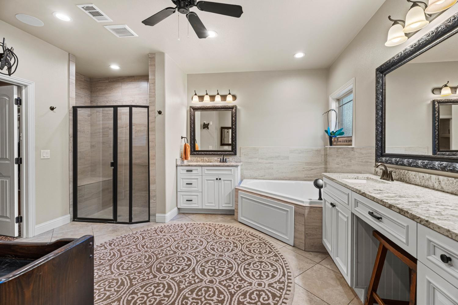813 Avenue T Shallowater, TX 79363 - Photo 16 of 36 a spacious bathroom with a granite countertop sink a toilet a mirror and shower