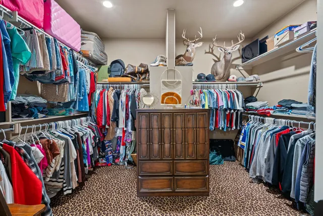 a view of walk in closet with clothes