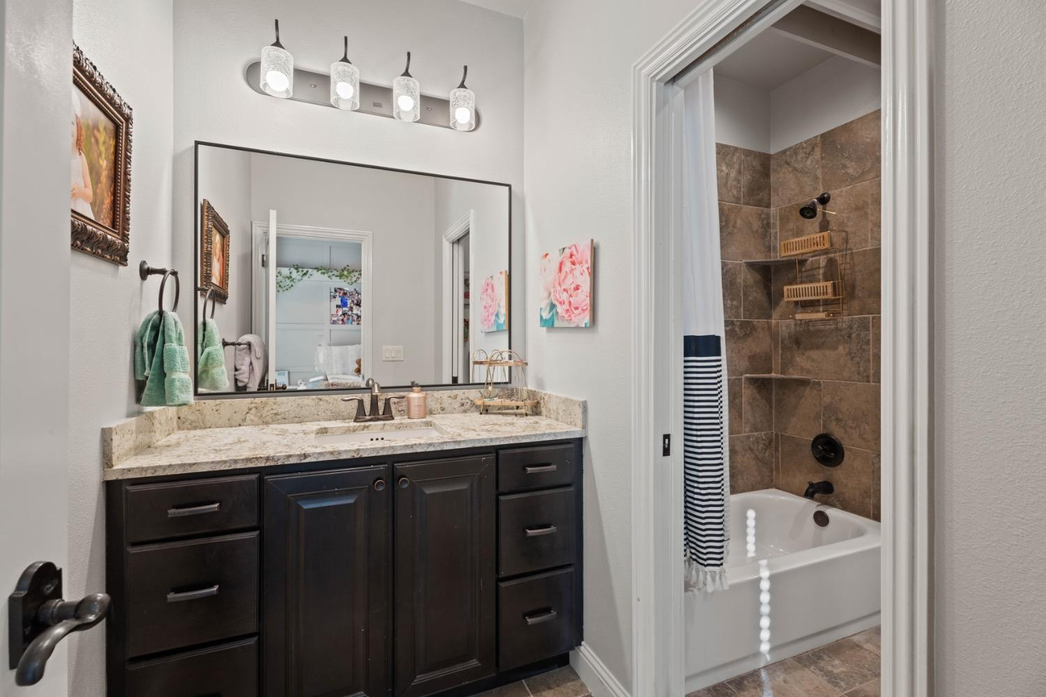 813 Avenue T Shallowater, TX 79363 - Photo 23 of 36 a bathroom with a granite countertop sink and a mirror