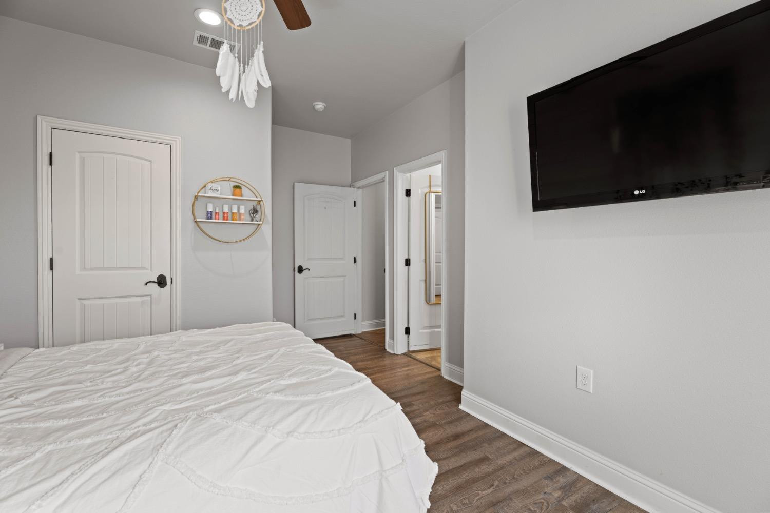 813 Avenue T Shallowater, TX 79363 - Photo 27 of 36 a bedroom with a bed and a flat screen tv