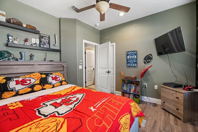 a bedroom with a bed and dresser