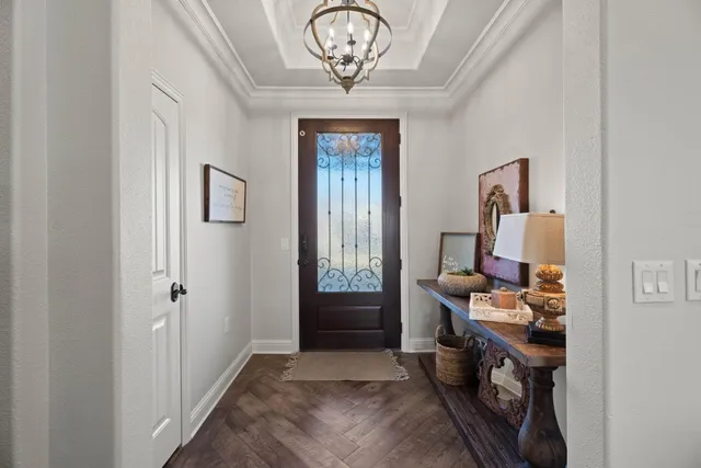 a view of a hallway with workspace and a window