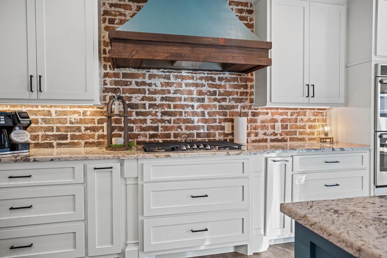 813 Avenue T Shallowater, TX 79363 - Photo 10 of 36 a kitchen with granite countertop white cabinets and appliances